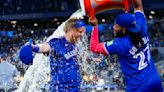 Justin Turner of the Toronto Blue Jays gets dunked with water by teammate Vladimir Guerrero Jr. after their team defeated the Colorado Rockies at the Rogers Centre...