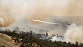 California wildfire does not grow but winds and hot weather could whip up flames