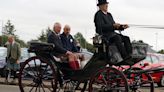 Charles strokes Clydesdale horses and enjoys carriage ride on Lanark visit