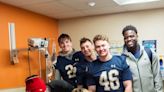 Notre Dame players, Tony the Tiger visit kids in local hospitals