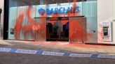 Four arrested after Barclays bank covered in paint