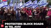 Protesters block roads in Tel Aviv and Jerusalem as they mark nine months since start of Gaza war