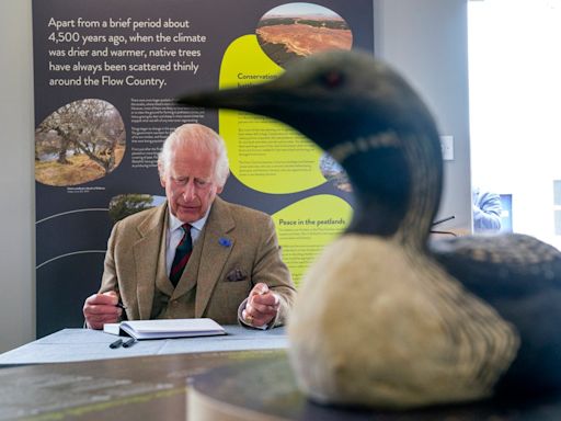 King Charles complains about his pen as he signs visitor book on nature reserve visit