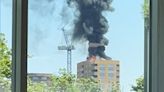 Tower block erupts into flames with plume of black smoke seen for miles