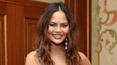 Chrissy Teigen Covers “SI Swimsuit” in Barely There One-Piece 10 Years After Her Last Sexy Appearance