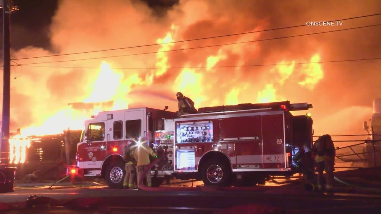 Firefighter injured after blaze torches stacked pallets, vehicles, trucks and trailers