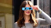 Kaia Gerber accessories a Carrie Bradshaw-esque outfit with solar eclipse glasses