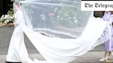 Watch: Bride Olivia Henson struggles with dress train and veil in the wind