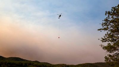 Cooler temps and rain could help corral blazes that forced thousands to flee New Mexico village