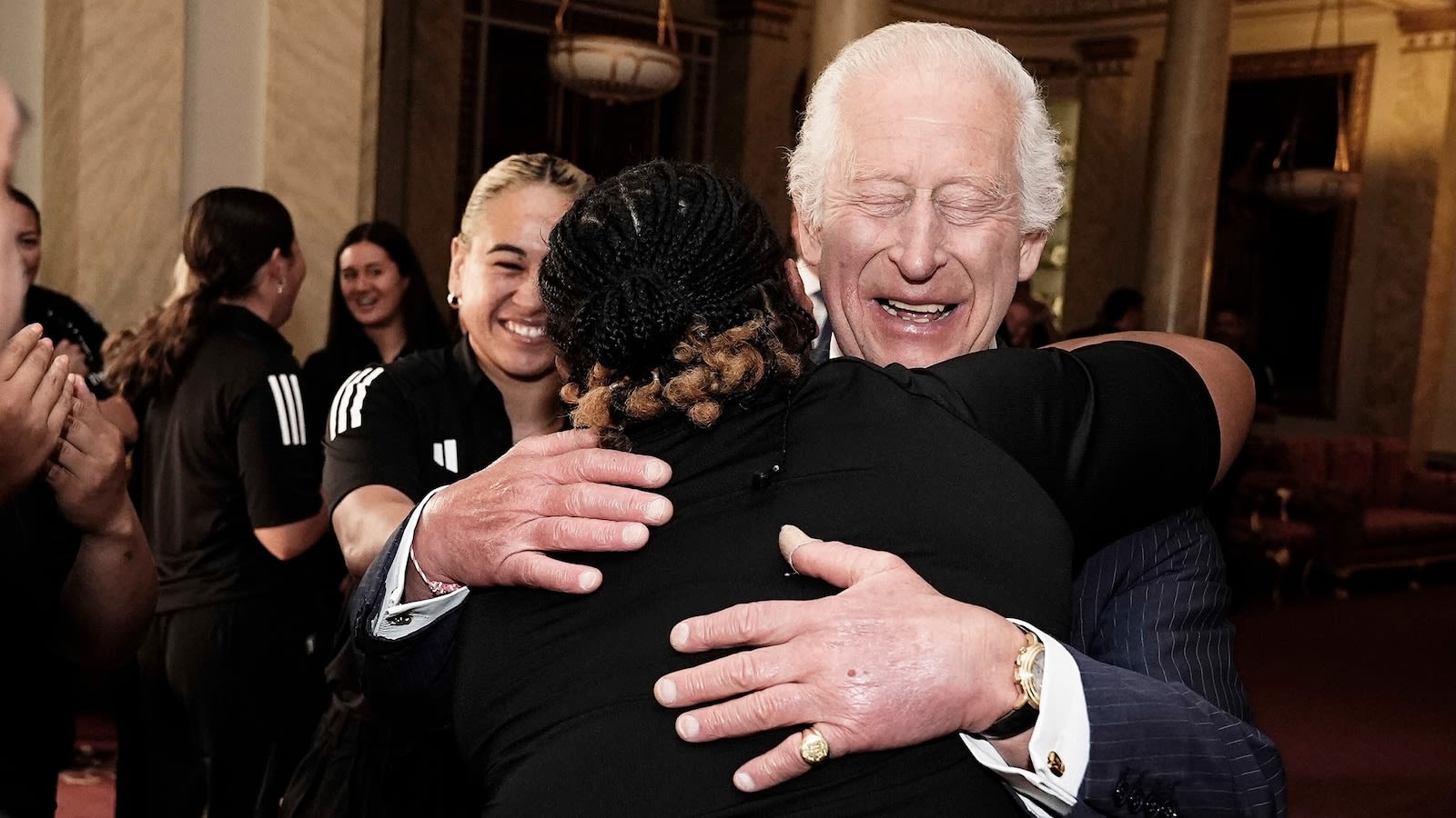 King Charles gets a group hug with New Zealand women's rugby team