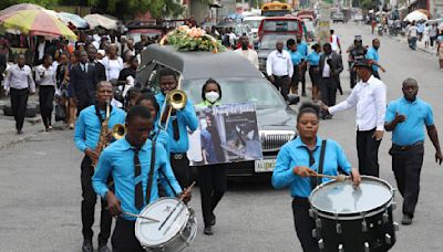 Hundreds mourn gang killings of a Haitian mission director and a young American couple