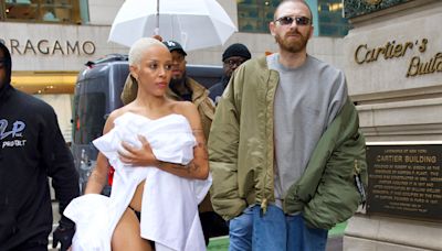 Doja Cat goes topless & exposes black thong as she shops wrapped in bed linen