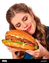 Girl eating big sandwich. Isolated Stock Photo - Alamy