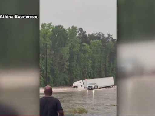 When all you see is truck top, it's time to go! Game Wardens helping families evacuate floodwaters