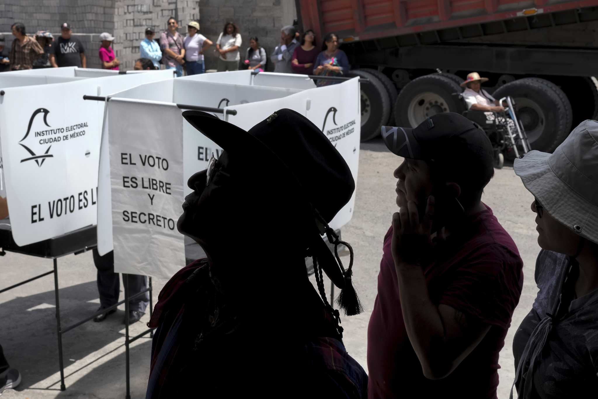The Latest | Mexico votes in historic elections marred by cartel violence and deep division