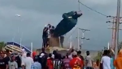 Manifestantes tumban la estatua de Hugo Chávez tras darse a conocer el resultado de la elección en Venezuela