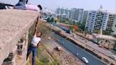 Dangerous stunts for Instagram reel! Pune teen hangs from edge of building holding hand of another; Triggers outrage | Today News