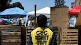 A security guard monitors the UCLA encampment