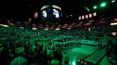 Michigan lights arena in Michigan State's green and white in honor of shooting victims