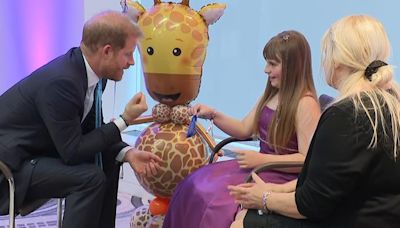 Prince Harry receives gifts from inspirational girl, 10, at WellChild Awards in London