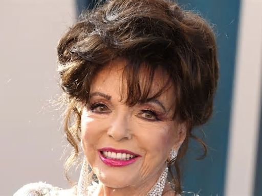 Joan Collins, 90, shows off unbelievable legs in a daring black halterneck swimsuit