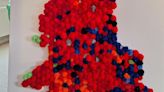 Couple create election map covered in red pom poms after tracking results