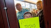 Satanic group gives Ottawa County board prayer as protesters chant, sing nearby