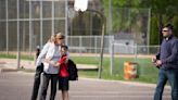 Teresa Mauer hugs her grandson Andy Mauer, 10, goodbye after watching her other granddaughter's softball game with her son Jake Mauer, at right, in St. Paul, Minnesota, on May 3, 2024.