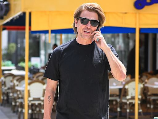 Jonathan Cheban flashes an arm tattoo as he chats on his cell