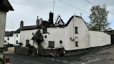 Dozens of firefighters tackle thatched roof blaze