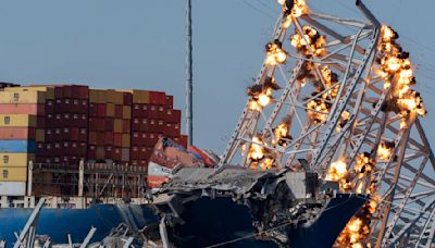 Collapsed Baltimore bridge span comes down with a boom after crews set off chain of explosives