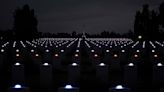 Photo slideshow: At Normandy, thousands of tombstones are lit by candle in memory of D-Day