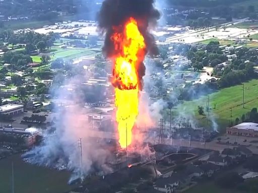 A pipeline explosion is shooting a towering pillar of flame over a Houston suburb