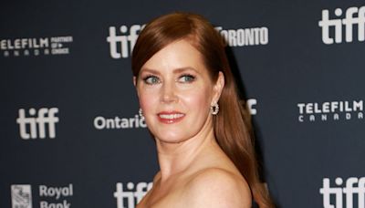 Amy Adams walks the TIFF red carpet after her run with the dogs in 'Nightbitch'