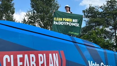 Greenpeace protester mounts Tory bus demanding ‘clean power not Paddy Power’