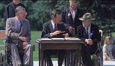 On this day in history, July 26, 1990, President George H.W. Bush signs Americans with Disabilities Act