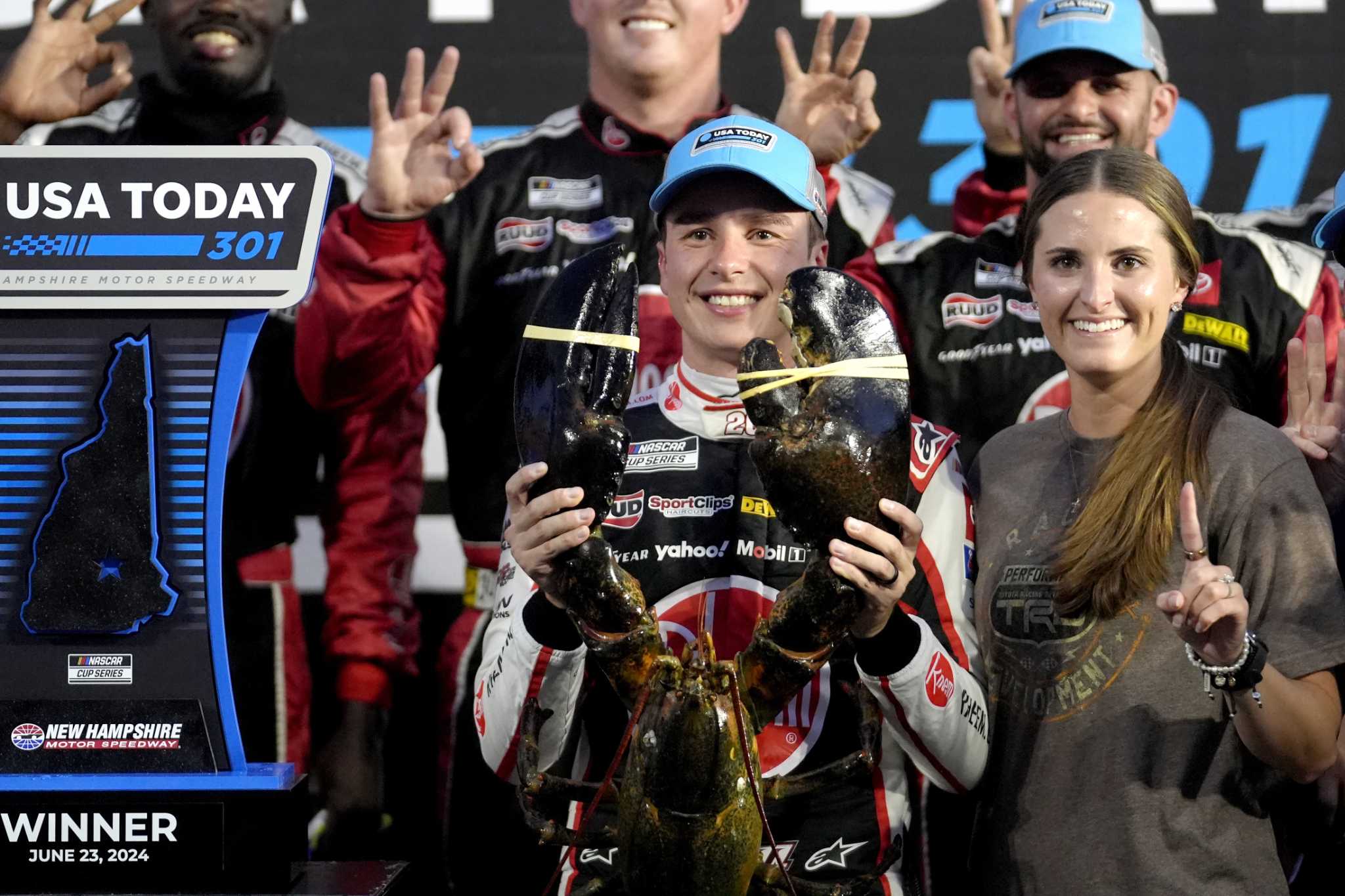 Christopher Bell takes the checkered flag on rain tires in the NASCAR Cup race at New Hampshire