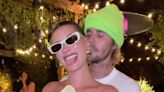 Hailey Bieber caresses her growing baby bump with husband Justin