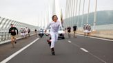 Crowds greet Olympic torch traveling through France under tight security