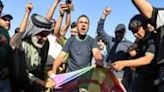 ...Shiite Muslim leader Moqtada Sadr burn a rainbow flag outside the Swedish embassy in Baghdad, after they breached the building over the burning of the Koran by an Iraqi living in Sweden