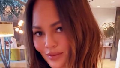 Chrissy Teigen shares glimpse of breast lift scars on date night