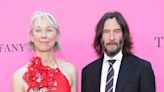 Keanu Reeves shares a kiss with Alexandra Grant during rare red carpet appearance together