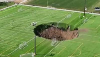 Huge sinkhole '100ft deep' opens up in middle of Illinois football pitch