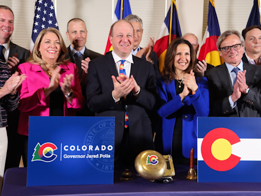 Polis signs Colorado budget, touts funding for schools and affordable housing