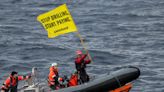 Footage shows the moment Greenpeace activists scaled a Shell oil platform that was being transported in 'rough conditions' in the Atlantic