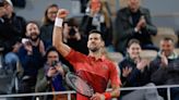 Novak Djokovic keeps his French Open title defense going by getting past Lorenzo Musetti in 5 sets