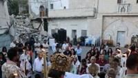 A Palestinian Orthodox Christian priest guides Easter mass for the minority community in Gaza, outside the Church of Saint Porphyrius in Gaza City