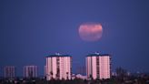 Full moon and summer solstice fall on same day. Strawberry moon peeks out briefly above horizon