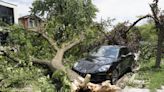 A dam fails after rain, wind, tornadoes pound the Midwest. The Chicago area is cleaning up