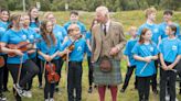 King battles midges on visit to Highland peat bog declared world heritage site